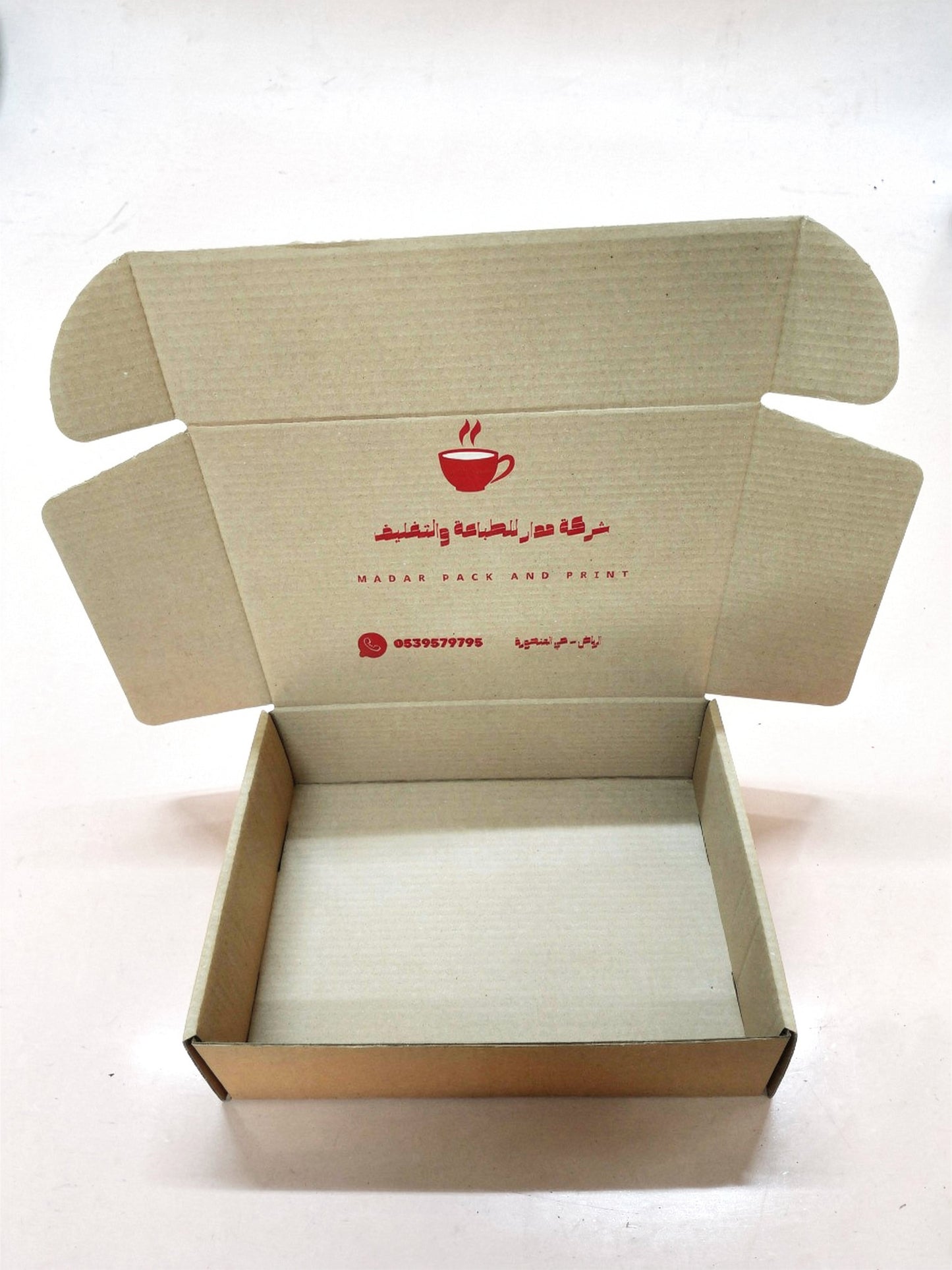 Open kraft paper box, custom printed, perfect for packaging coffee or small gifts.