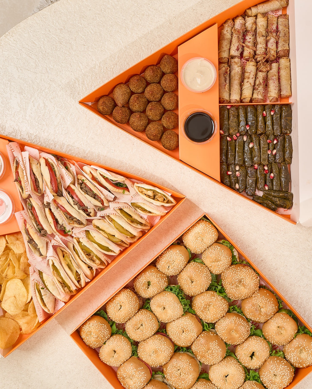Catering box assortment reference showing open and divided layouts for appetizers and sandwiches