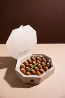 Open white octagonal gift box reference filled with assorted bite-size sweets