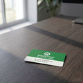 Small ألوان كاملة ID card مع vibrant design موضوع على textured dark مكتب خشبي in an office setting.
